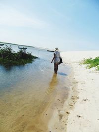 Full length of woman standing on shore