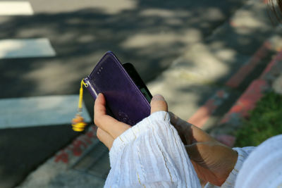 Midsection of woman holding umbrella