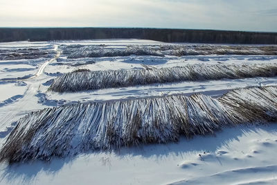 Scenic view of frozen lake against sky during winter