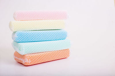 Stack of multi colored pencils against white background