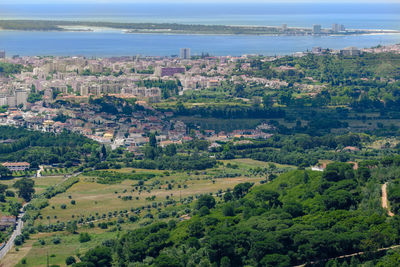 High angle view of buildings by sea against sky