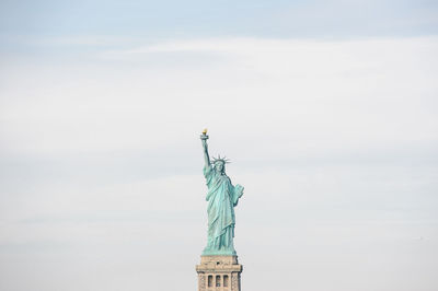 Statue of liberty against cloudy sky