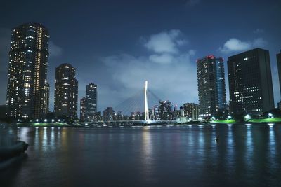 River with illuminated built structures in distance