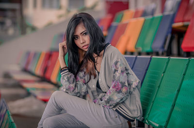 Portrait of woman sitting outdoors