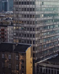 Urban view of obscure residential buildings and midernist high rise