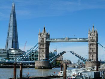 View of suspension bridge against blue sky