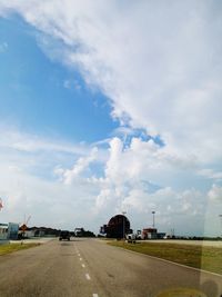 Road by city against sky