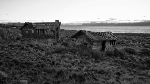 Old house on field against sky