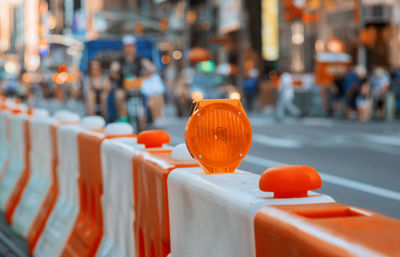 Close-up of orange balloons on street in city
