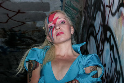 Portrait of female model with face paint in tunnel