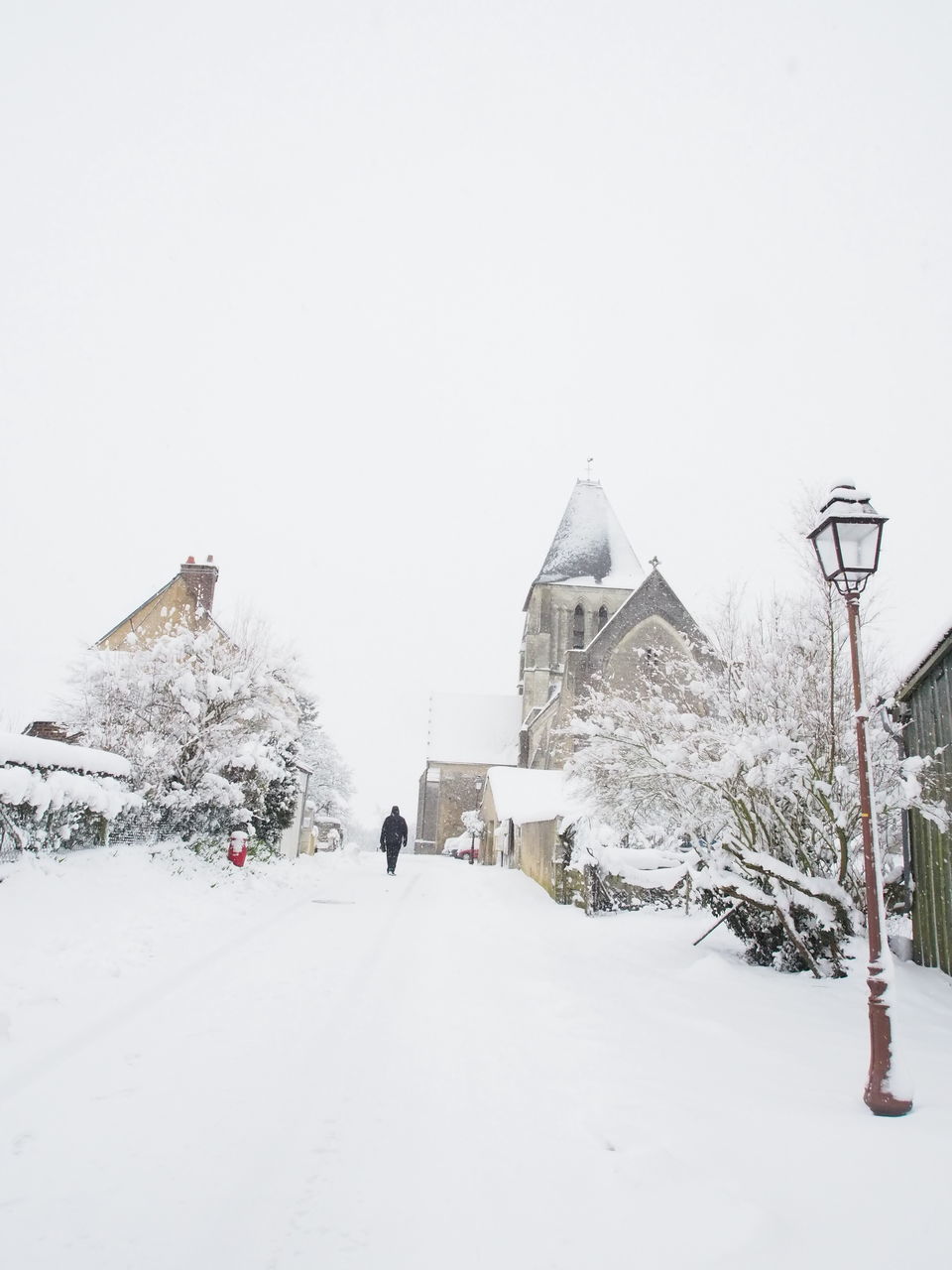 PEOPLE WALKING IN SNOW COVERED LANDSCAPE