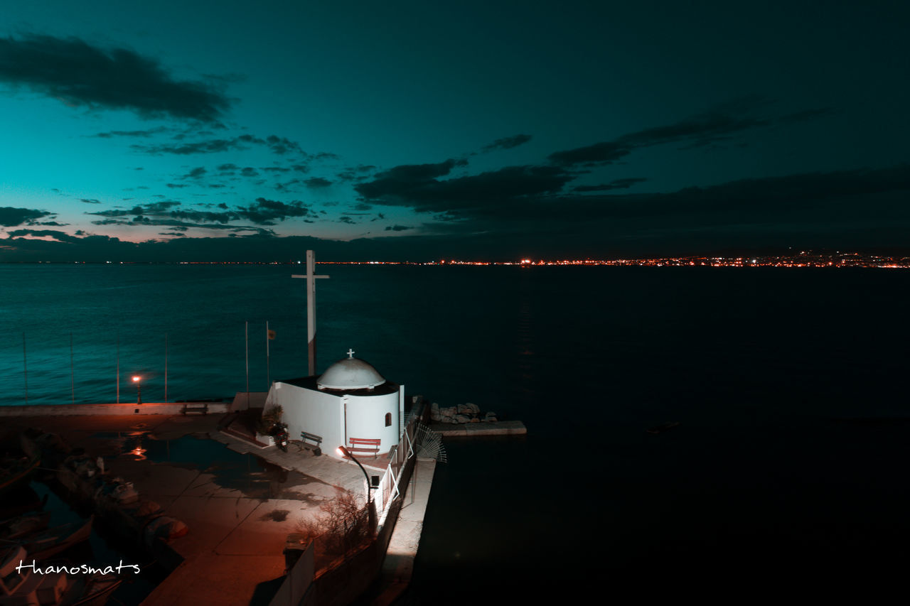 BOATS MOORED IN SEA AGAINST SKY AT NIGHT