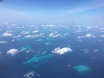 Aerial view of sea against blue sky