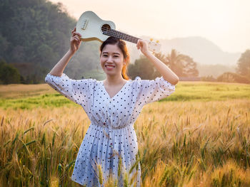 Young woman standing on field