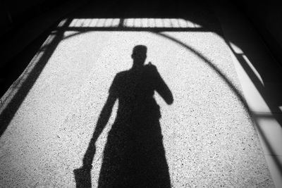 Shadow of man on tiled floor