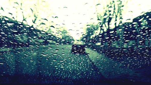 Full frame shot of wet glass window in rainy season