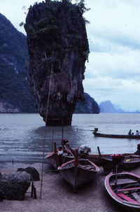 Boats moored at beach against sky