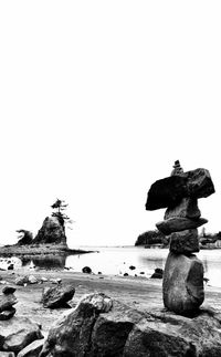 Close-up of statue on beach against clear sky