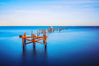 Wooden posts in sea