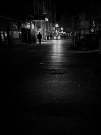 Man walking in city at night