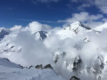 Scenic view of snow covered mountains against sky