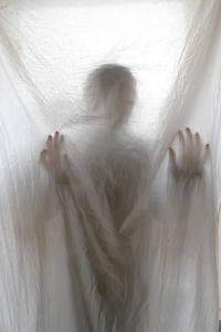 Defocused image of woman lying on bed