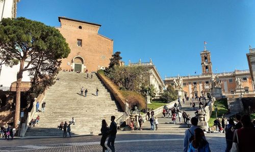 People walking in front of historical building