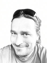 Close-up portrait of young man against white background