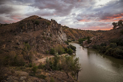 Scenic view of river amidst mountains against sky