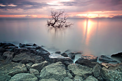 Scenic view of beach against sky during sunset