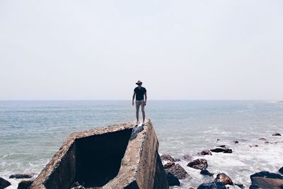 Rear view of woman standing on beach