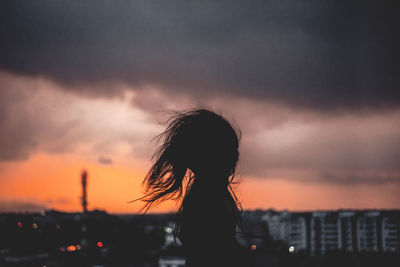 Silhouette woman against sky during sunset