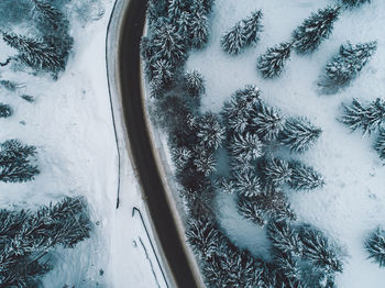 Aerial view of road by snow covered land during winter