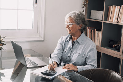 Senior woman working in office