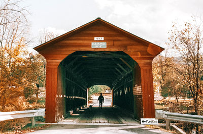 Rear view of man on bridge against sky