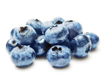 Close-up of blueberries against white background