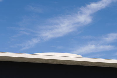 Low angle view of building against cloudy sky