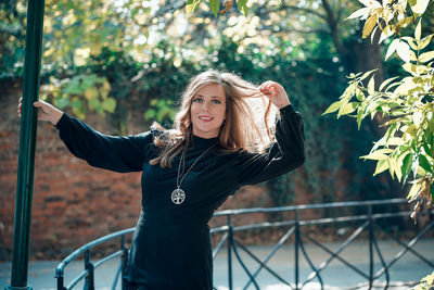 Portrait of smiling young woman standing outdoors