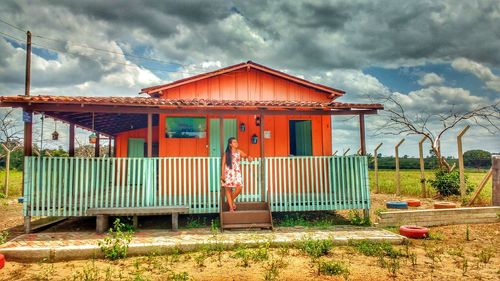 Built structure in front of house against cloudy sky