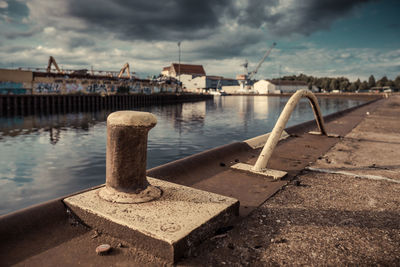 Close-up of bollards at harbor