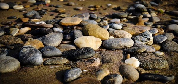 Pebbles on rocks at beach