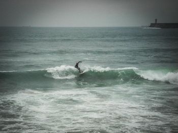 People surfing in sea