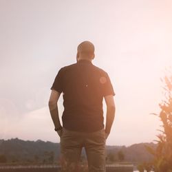 Rear view of silhouette man standing against clear sky