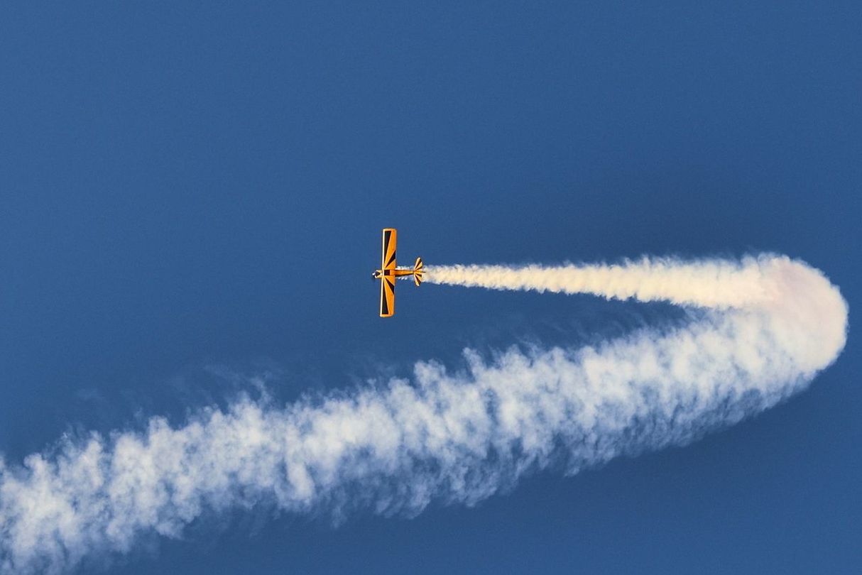 sky, air vehicle, airplane, vapor trail, flying, cloud - sky, mode of transportation, transportation, on the move, low angle view, blue, motion, no people, smoke - physical structure, airshow, nature, mid-air, day, outdoors, travel, plane, aerobatics, trail