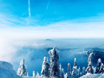 Panoramic view of snowcapped mountains against blue sky