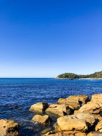 Scenic view of sea against clear blue sky