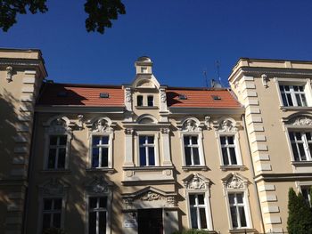 Low angle view of building against clear blue sky