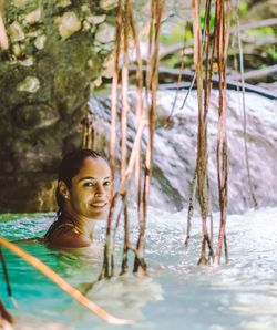 Portrait of smiling young woman in water