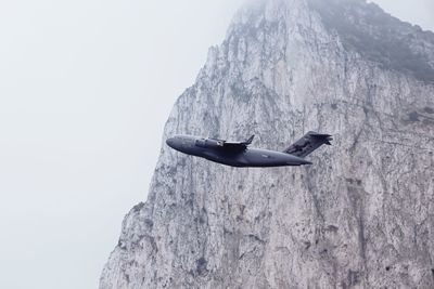 Low angle view of rock formation on mountain against clear sky