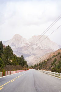 Road amidst mountains against sky